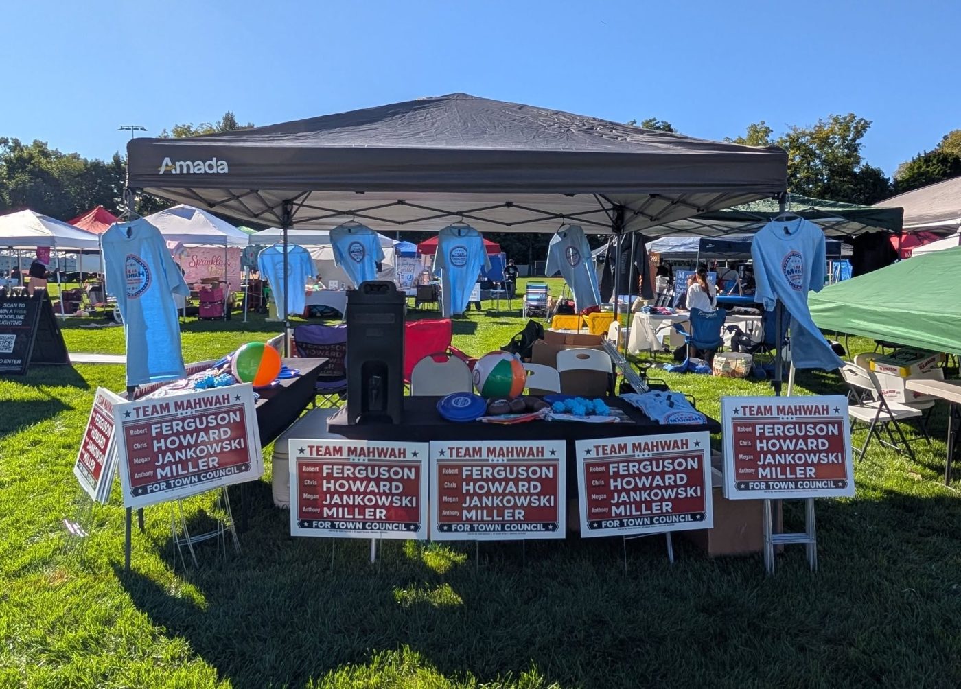 The Team Mahwah booth at Mahwah Day with yard signs, t-shirts and giveaways
